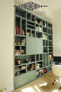 a room with a desk, bookshelf and chair