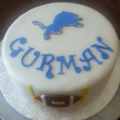 a birthday cake with the word gummy written on it, and a football helmet