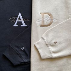 three different colored shirts with the letter d on one side and an initial on the other