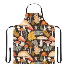 an apron with mushrooms, leaves and acorns printed on the front in black