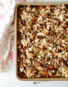 a baking dish filled with granola and nuts