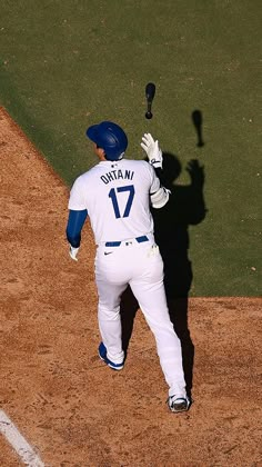 a baseball player holding a bat on top of a field