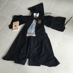 a harry potter costume laying on the floor