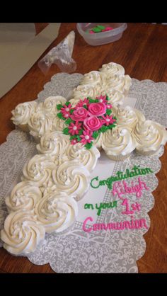 a cake with white frosting and pink flowers on it