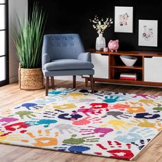 a living room with black walls and colorful rugs