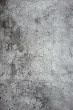 an old grungy concrete wall with cracks in it