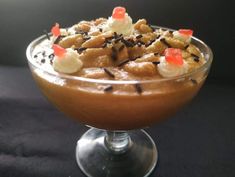 a dessert in a glass bowl with sprinkles and candies on top