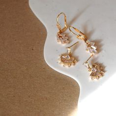 Dainty delicate art deco inspired earrings add the perfect sparkle. gold plated leverback earwires cubic zirconia 1.25 in x .2 in Elegant Rose Gold Cluster Earrings With Cubic Zirconia, Elegant Rose Gold Cubic Zirconia Cluster Earrings, Dainty Diamond Earrings Tarnish Resistant, Elegant Yellow Gold Chandelier Earrings With Cubic Zirconia, Dainty Tarnish-resistant Diamond Earrings, Chandelier Earrings With Diamond Accents As Gift, Cubic Zirconia Chandelier Earrings With Diamond Accents As Gift, Cubic Zirconia Chandelier Earrings With Diamond Accents, Cubic Zirconia Chandelier Drop Earrings