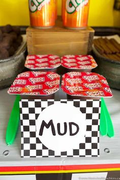 there is a sign that says mud in front of some cookies and other food items