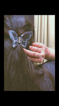 a woman with her hands on top of her hair