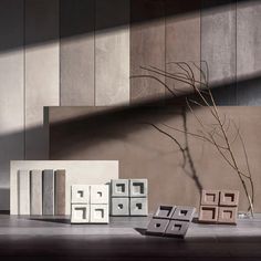 some boxes and a plant in front of a wall with concrete blocks on the floor