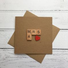 two pieces of wood with the word mr and mrs spelled in scrabble letters