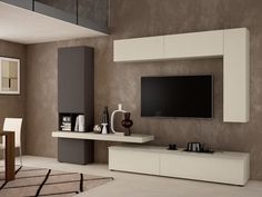 a modern living room with white furniture and a flat screen tv mounted on the wall