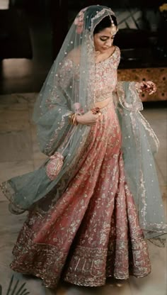 a woman in a pink and green lehenga