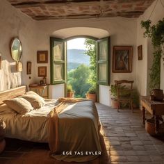 a bedroom with an arched window and stone flooring, overlooking the valley outside it