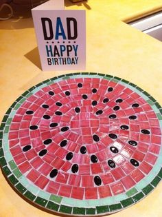 a watermelon mosaic table top with black dots on it