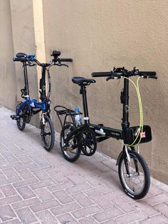 two bikes parked next to each other on a sidewalk