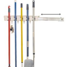 an assortment of tools hanging on a wall with hooks and pegs attached to it