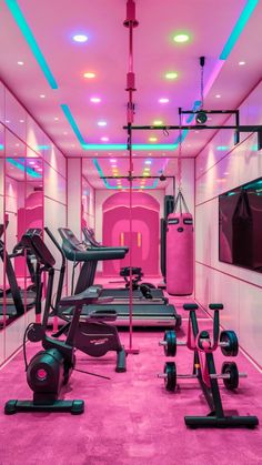 an exercise room with pink carpet and neon lights on the ceiling, including treadmills