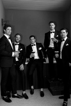 a group of men in tuxedos standing next to each other