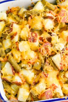 a casserole dish with potatoes, green beans and cheese