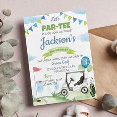 a birthday party card with a golf cart on it next to some cotton balls and flowers