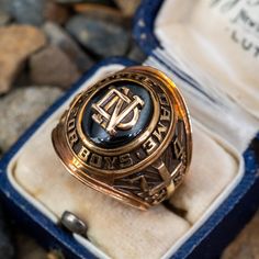 This awesome 1974 class ring from Notre Dame for Boys features an oval green glass stone with a ND plaque in the center. The ring is crafted of 10k yellow gold with a natural unpolished rich patina. This ring is currently a size 7. We are not offering resizing due to the design. The inside of the shank is engraved with the initials KGM. 1990 Class Ring, 1976 Class Ring, Notre Dame College, Black Star Sapphire, Star Sapphire Ring, Sapphire Cabochon, Brandon Lee, Championship Rings, Drop Design