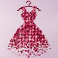 a dress made out of beads on a pink background