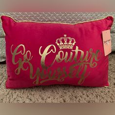 a pink pillow with gold lettering and a crown on it that says, courre princess