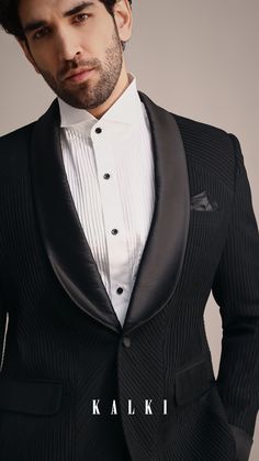 Make a statement in our Black Tuxedo tailored from fine terry rayon.
The subtle self work and pintuck accents add a modern touch to a timeless design.
Perfect for receptions and upscale events this tuxedo ensures you look sharp and stylish.
The tuxedo is paired with a shirt and a trouser. Indian Groom Wear, Indian Groom, Groom Wear, Designer Suits, Pin Tucks, Hand Embroidery