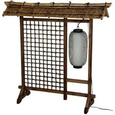 Four foot tall Oriental room divider with multiple decorative components. Open lattice features fiber ties at each joint. Hanging black electric lantern is wired for American light bulbs and plugs into a standard American outlet. Rustic thatched roof of natural fiber has bamboo poles stained a dark walnut. Footed triangular feet add stability and style. A bold, practical Oriental light and divider for the home or office. Size: 51 inch. Color: Brown. Fabric Room Dividers, Portable Room Dividers, Glass Room Divider, Bamboo Room Divider, Bamboo Lantern, 4 Panel Room Divider, Hanging Room Dividers, Folding Room Dividers, Glass Room