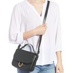 The Crossbody Bag Is Crafted From Italian Leather And Includes An Interior Pocket And A Card Slot. It Features An Optional Top Handle For Hand Carry And Is Perfectly Sized To Hold The Daily Essentials. - Top Handle - Detachable, Adjustable Shoulder Strap - Magnetic - Exterior Slip Pocket - Interior Zip Pocket - Approx. 8.5" W X 6.5" H X 2.5" D - Approx. 21-23" Strap Drop, 3" Handle Drop Chic Travel Saddle Bag With Branded Hardware, Chic Saddle Bag With Branded Hardware And Crossbody Shape, Chic Crossbody Saddle Bag With Branded Hardware, Elegant Workwear Saddle Bag With Branded Hardware, Elegant Saddle Bag With Branded Hardware For Work, Elegant Saddle Bag For Work With Branded Hardware, Chic Everyday Flap Bag With Branded Hardware, Gold-tone Hardware Crossbody Flap Bag For Work, Workwear Crossbody Flap Bag With Gold-tone Hardware