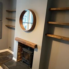 a living room with a fire place and shelves