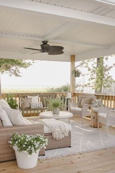 a porch with wicker furniture and a ceiling fan