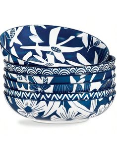 four blue and white bowls are stacked on top of each other, one is decorated with flowers