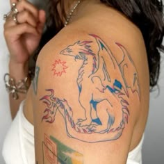 a woman with a dragon tattoo on her shoulder