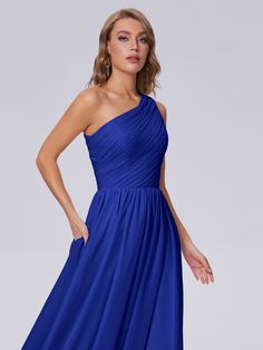 a woman in a blue dress posing for the camera