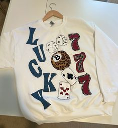 a white shirt with the words lucky jack written on it and some dices in front