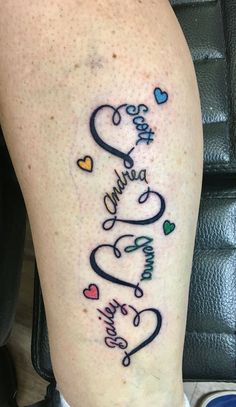 a tattoo on the leg of a person with hearts and words written in cursive writing