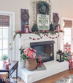 a fireplace decorated for christmas with stockings and presents on the mantel, along with other holiday decorations