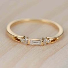 a gold ring with three stones on it