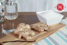 ginger root on a cutting board next to a bowl and spoon