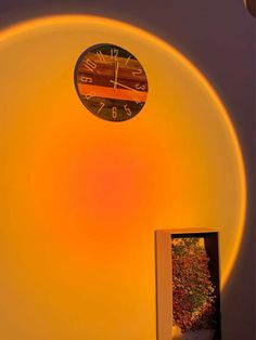 a clock on top of a round object in the middle of a room with yellow light