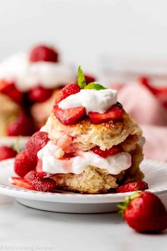 strawberry shortcakes with whipped cream and fresh strawberries on the side, ready to be eaten