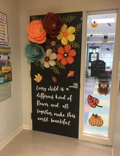 a door decorated with flowers, leaves and a quote on it that says every child is a different kind of flower, and all together make this world beautiful