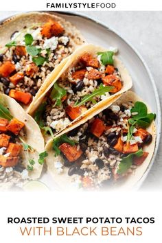 three roasted sweet potato tacos with black beans and feta cheese on a white plate