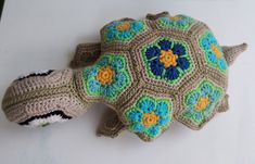 a crocheted turtle is sitting on the table