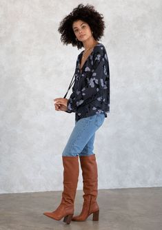 With timeless elements like a self-covered button front and voluminous long sleeves, our floral print bohemian blouse is this season's must-have style. Featuring a split neckline with ties and delicately gathered details at the back. A mini pom trim along the flounce wrist cuff adds a whimsical touch to this classic top. Floral print Relaxed fit Long voluminous raglan sleeve Elastic flounce wrist cuff with mini-pom trim Hip length Split v-neckline with ties Self-covered button front Bohemian pea Bohemian Blouse With Gathered Sleeves For Fall, Fall Floral Print Peasant Top With Balloon Sleeves, Fall Peasant Top With Blouson Sleeves, Fall Peasant Top With Blouson Sleeves And Flowy Fit, Fall Blouse With Blouson Sleeves And Split Neck, Chic Floral Print Long Sleeve Peasant Top, Chic Long Sleeve Floral Print Peasant Top, Chic Long Sleeve Floral Peasant Top, Chic Long Sleeve Peasant Top With Floral Print