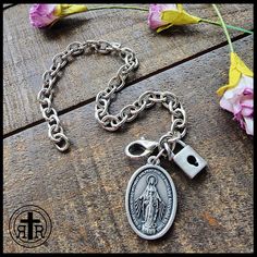 We are proud to offer this women's Consecration to Mary bracelet at such an affordable price. Our version has Our Lady's Miraculous Medal and a small Lock to remind you of your devotion. Antique Silver medal Chain Sturdy lobster clasp. Fits up to size 8.25 inches. Official Act of Consecration to Mary (DOWNLOAD a printable version HERE) Written by St. Maximilian Kolbe O Immaculata, Queen of Heaven and earth, refuge of sinners and our most loving Mother, God has willed to entrust the entire order Miraculous Medal Bracelet Jewelry Gift, Spiritual Stainless Steel Jewelry With Lobster Clasp, Spiritual Charm Bracelet As Gift, Spiritual Metal Chain Bracelet With Lobster Clasp, Spiritual Rosary Bracelet With Lobster Clasp As Gift, Spiritual Metal Rosary Bracelet As Gift, Spiritual Chain Bracelet With Lobster Clasp As Gift, Nickel Free Spiritual Chain Bracelet Gift, Nickel-free Spiritual Chain Bracelet Gift