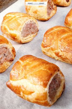 several pastries sitting on top of a piece of wax paper